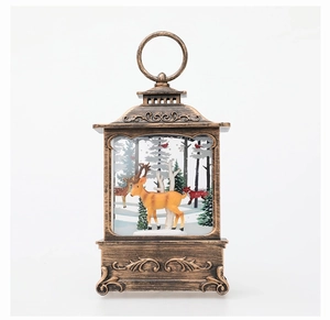 Detail of vintage Christmas lantern with miniature deer and white birch trees inside