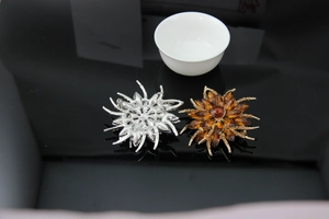 Detailed front and back views of large crystal flower brooches with pins