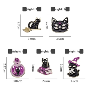 Detail of purple enamel cat pins showing Halloween elements like witch hats and potions