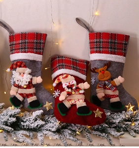 Hanging Christmas stockings with 3D Santa, Snowman and Reindeer characters on plaid cuffs