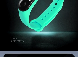 Detail of green silicone sports watch strap with touch screen on a dark background