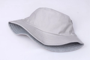 Detailed side view of a light gray embroidered bucket hat with a clean flat-top design