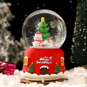 Christmas music box crystal ball with snowman and Christmas tree on a red base