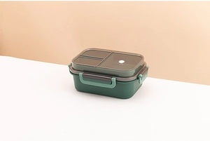 Detail of green double-layer lunch box with two compartments and airtight side buckles