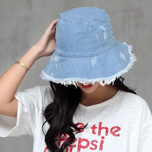 Unisex light blue denim bucket hat with distressed frayed edges and a flat top crown