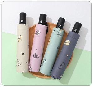 Detail of four colorful cartoon umbrellas with cat patterns in a wooden tray