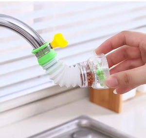 Detail of extendable faucet filter with mineral balls and turbo fan on metal tap