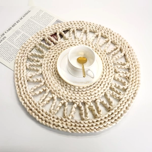 Detail of woven corn husk placemat with hollowed lace edge and decorative tea cup