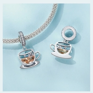 Macro shot of 925 silver coffee cup charm with brown gemstone and white zircon detail