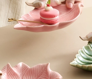 Pink bird ceramic leaf jewelry dish with gold spoon and macaron for small trinket storage