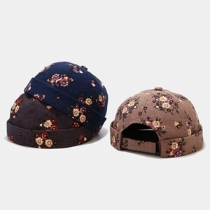 Detail of floral brimless caps with adjustable straps in navy, grey, and khaki colors