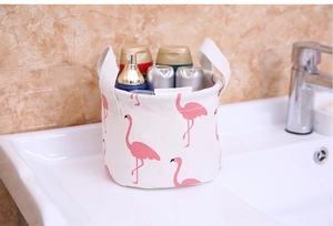Detail of flamingo print cotton linen organizer basket with handles for bathroom use