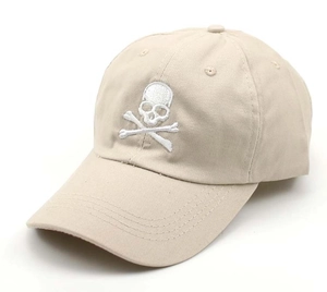 Detailed side view of beige baseball cap featuring white skull and crossbones embroidery