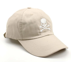 Detail shot of white skull embroidery on beige cotton canvas baseball cap surface