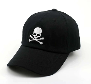 Close-up of high-quality white skull and crossbones embroidery on a black cotton baseball cap