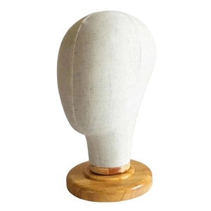 Detailed view of linen fabric display mannequin head with premium wooden base texture