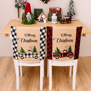 Detail of Christmas chair covers with vintage truck patterns and festive plaid borders