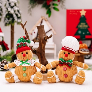 Close-up of plush gingerbread man dolls with knitted texture and festive Christmas ornaments