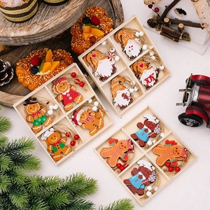 Boxes of wooden gingerbread man and gnome ornaments with pine cones for Christmas tree