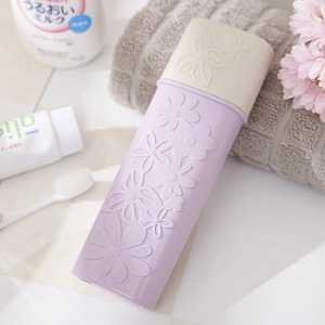Portable light purple and beige toothbrush travel case with floral embossed design