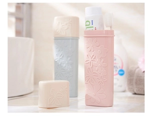 Detail of floral embossed plastic toothbrush cases in pink, blue, and beige colors