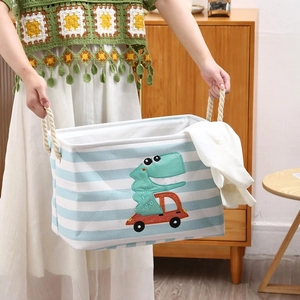 Blue striped canvas toy basket with dinosaur applique and rope handles for room storage