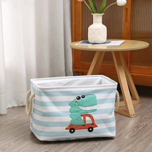 Detail of striped fabric storage basket with cartoon dinosaur and thick rope handles