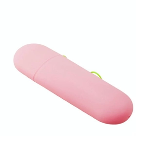 Pink candy-colored portable capsule toothbrush case with a green carrying loop lanyard