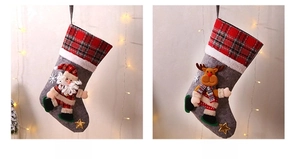 Detail of Christmas stocking featuring 3D Santa and Reindeer designs with red plaid fabric
