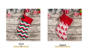 Detail of knitted Christmas stockings with zigzag waves and reindeer patterns with pom-poms