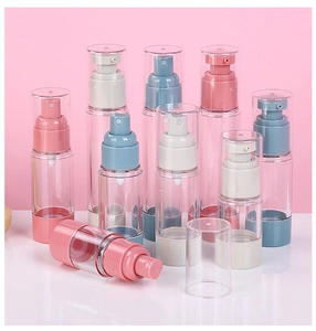 Detail view of colorful vacuum pump bottles for cosmetics in pink, blue, and beige tones