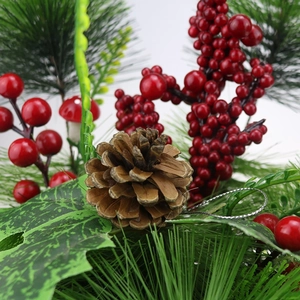 Detail of Christmas decoration featuring red berries, natural pine cones, and pine needles
