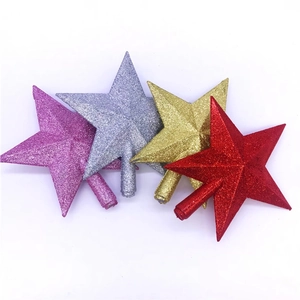 Detail of glittered star tree toppers in pink, silver, gold, and red with cone bases