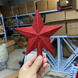 Close-up of a red glittered star tree topper held in hand with a secure socket base