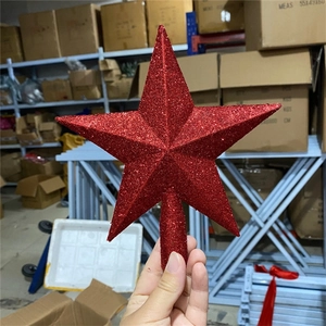 Detail of red glittered hollow base star topper for a festive Christmas tree decoration