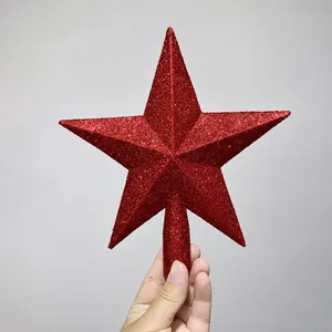 Detail of red glittered hollow base star topper for a festive Christmas tree decoration