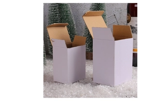 White cardboard gift boxes in two sizes shown on artificial snow for Christmas packaging