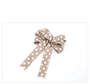 Close-up of 25cm burlap Christmas bow with white polka dots and dovetail cut edges