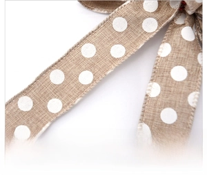 Close-up of burlap texture ribbon with white polka dots for Christmas tree decoration