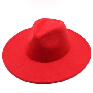 Classic wide brim red wool fedora hat for men and women featuring a flat brim and felt texture
