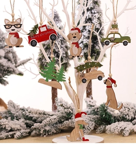 Detail of laser-cut wooden Christmas ornaments hanging on white branches with pine decor