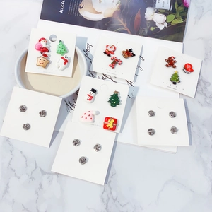 Detail view of colorful Christmas acrylic pins featuring snowman and elk on a card