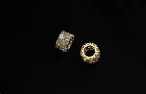 Macro shot of gold-plated silver bead with white cubic zirconia in prong setting