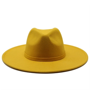 Detailed texture of yellow felt fedora hat featuring a matching decorative ribbon band