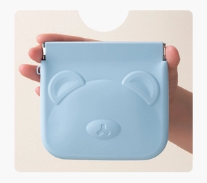 Blue silicone mini pouch with 3D bear design held in hand for digital accessories storage