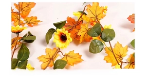 Close-up of fall garland featuring artificial sunflowers, maple leaves, and orange berries