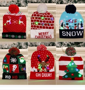 Detail view of 6 colorful knitted Christmas hats with LED lights and holiday motifs