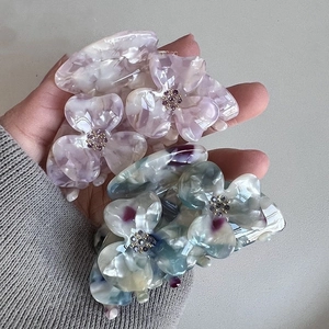 Floral acetate hair claw clips with rhinestones in pink and blue for elegant styling