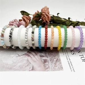Detail view of 6mm natural crystal stone beaded bracelets in multi-color elastic styles