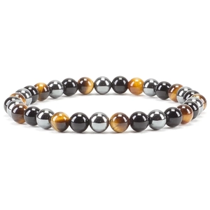 Detail of 6mm natural tiger eye and agate beaded elastic bracelet in a studio setting